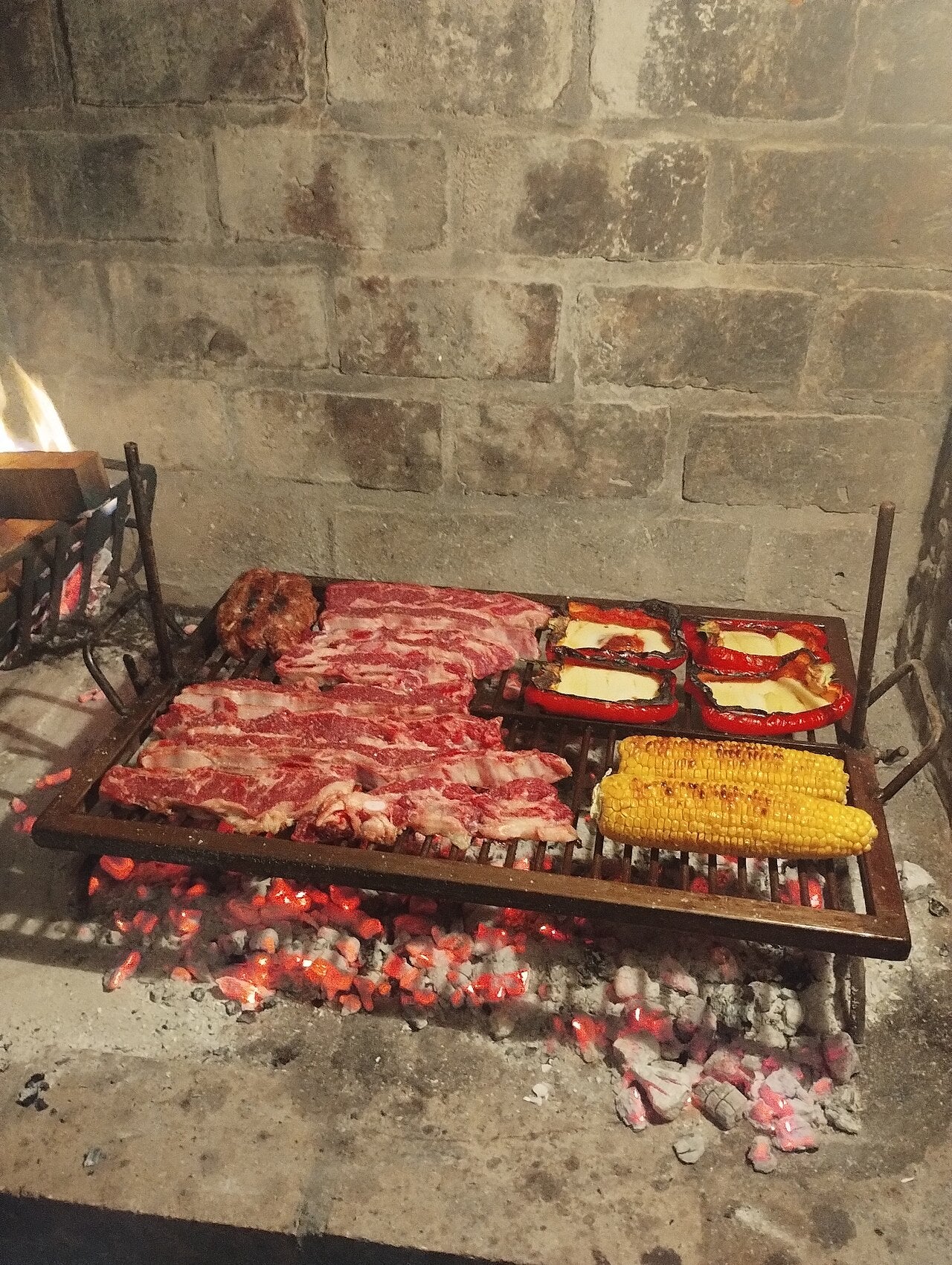 Asado cooking over coals