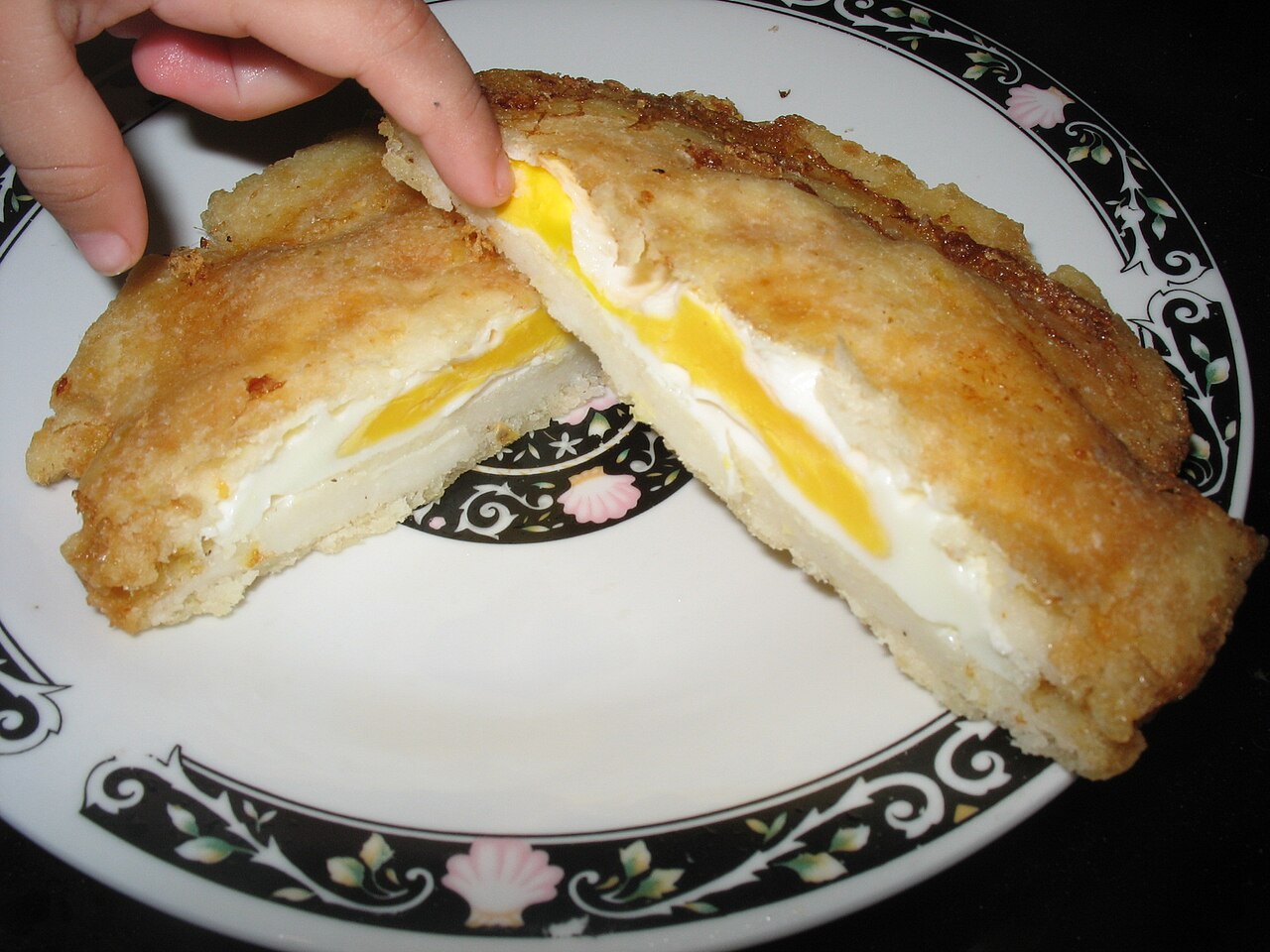 An arepa de huevo cut open; egg-only variation
